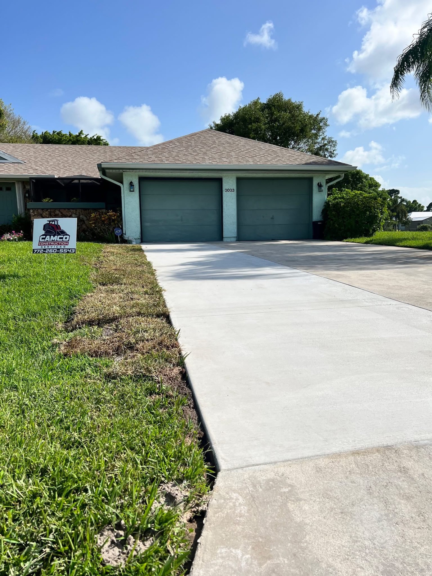 Finished concrete driveway and walkway at a two-car garage home in Stuart